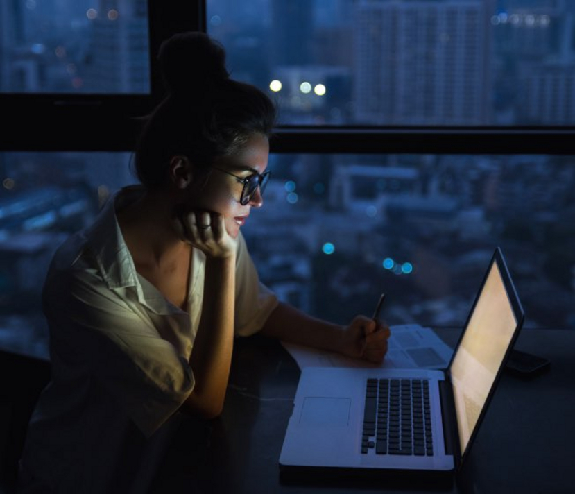 Frau vorm Laptop am späten Abend